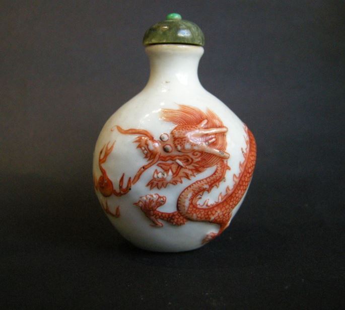 Snuff bottle porcelain with a low relief a Dragon in iron red | MasterArt